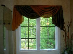 Simple but dramatic draped bathroom window treatment