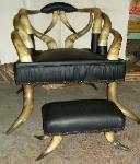 Horn Chair Upholstering chair and foot rest in black leather at Schindlers Upholstery Shop front view