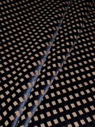 Draped curtain image of geometric pattern with chenille accents on espresso background